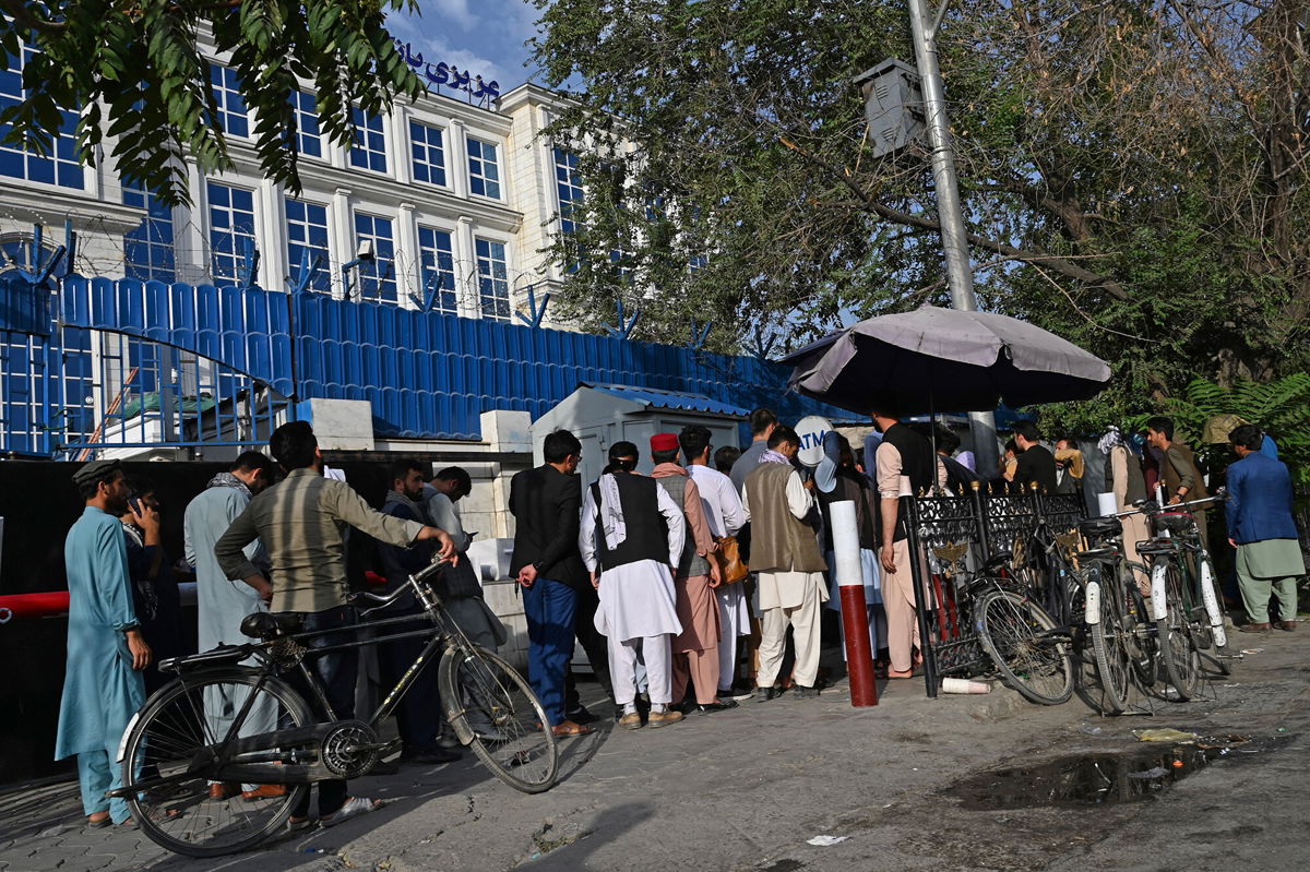 <i>AFP/Getty Images</i><br/>People in Afghanistan wait in line to withdraw money from an ATM in Kabul on August 21.