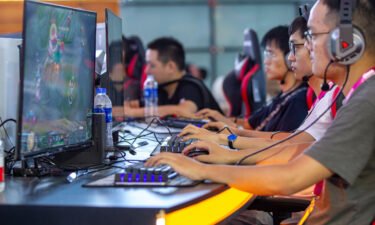 China bans kids from playing online video games during the week. Pictured are gamers at the Shanghai New International Expo Center on Aug. 1