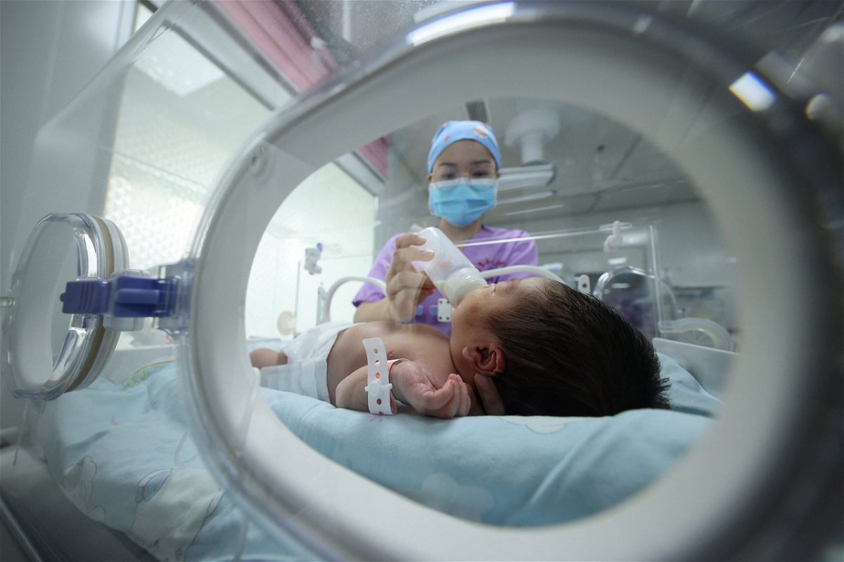 <i>STR/AFP/Getty Images</i><br/>A medical staff member here feeds a baby at a hospital in Danzhai