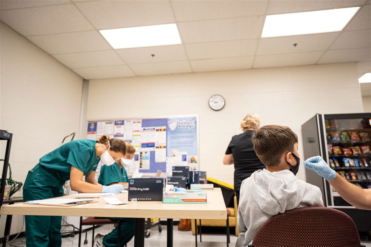 <i>Jon Cherry/Getty Images</i><br/>Child Covid-19 cases are steadily increasing. A student gets a Covid-19 test at Brandeis Elementary School on August 17