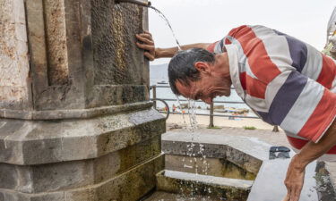 A man finds some reprieve from the heat in Messina on the Italian island of Sicily on Aug. 11.