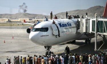 Afghan people climb atop a plane attempt to leave Kabul on Aug. 16. The US has come under scrutiny over its hasty and chaotic withdrawal