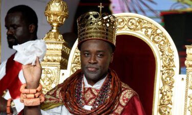 Prince Tsola Emiko waves after being crowned as the 21st king or the Olu of Warri kingdom and the Ogiame Atuwatse III during his coronation at Ode-Itsekiri on August 21.