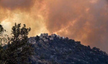 Smoke rises from a wildfire in the forested hills of the Kabylie region on August 10.