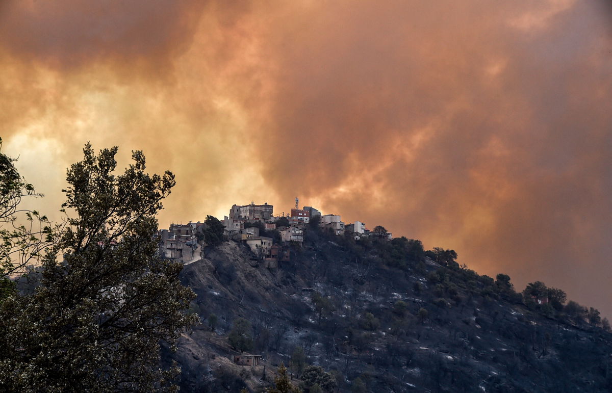 <i>Ryad Kramdi/AFP/Getty Images</i><br/>Smoke rises from a wildfire in the forested hills of the Kabylie region on August 10.