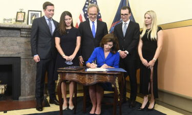 Kathy Hochul signs documents at her swearing-in the state Capitol in Albany