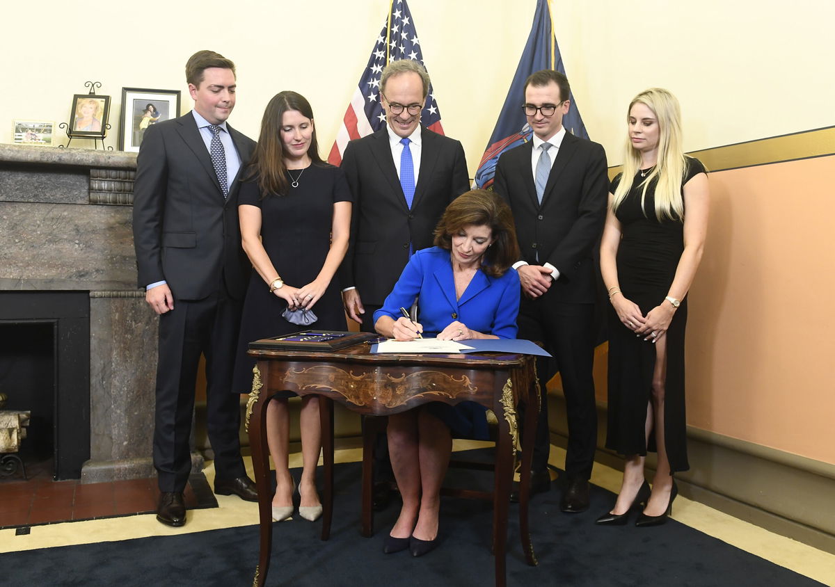 <i>Hans Pennink/Pool/Getty Images</i><br/>Kathy Hochul signs documents at her swearing-in the state Capitol in Albany