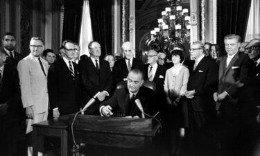President Lyndon B. Johnson signs the Voting Rights Act of 1965 in a ceremony in the President's Room near the Senate chambers in Washington