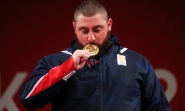 Gold medalist Lasha Talakhadze of Team Georgia poses with the gold medal during the medal ceremony for the Weightlifting - Men's 109kg+ Group on day 12 of the Tokyo 2020 Olympic Games.