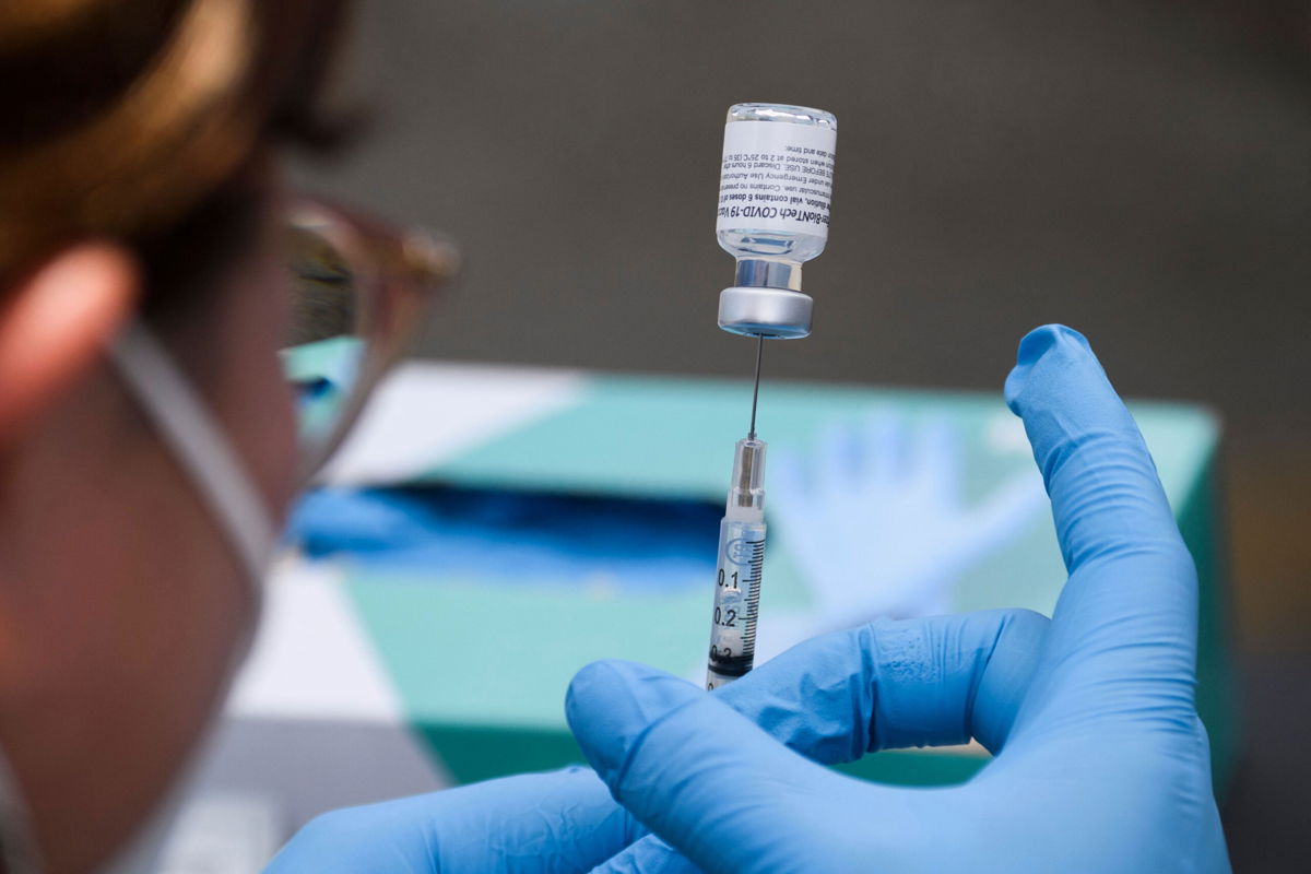<i>Patrick T. Fallon/AFP/Getty Images</i><br/>A syringe is filled with a first dose of the Pfizer Covid-19 vaccine at a mobile vaccination clinic in Los Angeles