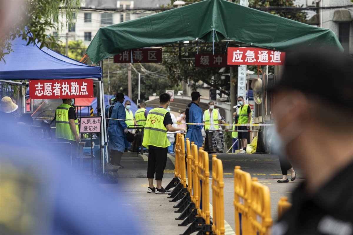 <i>Qilai Shen/Bloomberg/Getty Images</i><br/>China reported no new locally transmitted Covid-19 cases on Monday for the first time since July. A neighborhood is here placed under lockdown in Shanghai