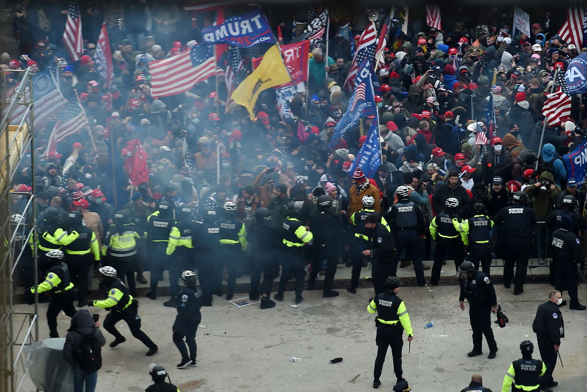 <i>Olivier Douliery/AFP/Getty Images</i><br/>Police hold back rioters as they gather outside the US Capitol's rotunda on January 6