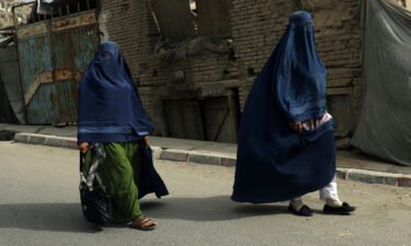 Taliban told working women to stay at home because soldiers are 'not trained' to respect them. Afghan women in burqas here walk on a street in Kabul