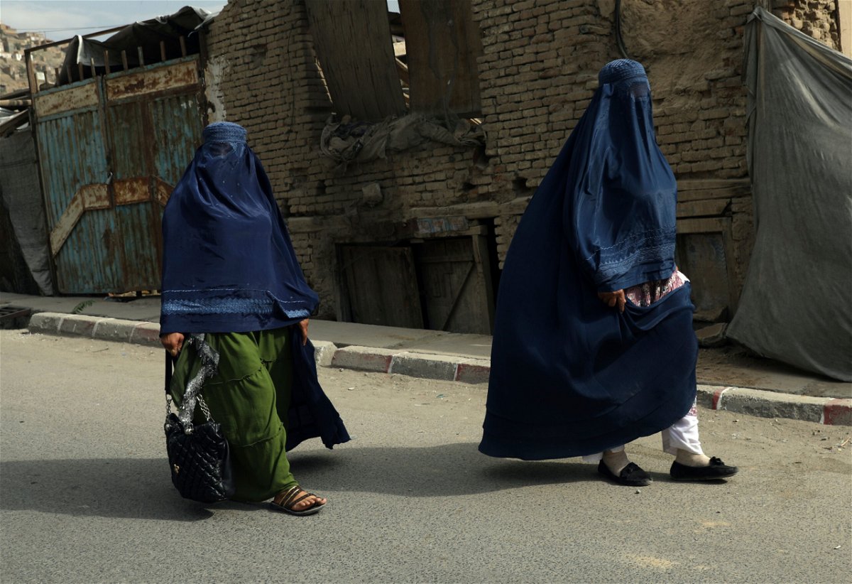 <i>Rahmat Gul/AP</i><br/>Taliban told working women to stay at home because soldiers are 'not trained' to respect them. Afghan women in burqas here walk on a street in Kabul