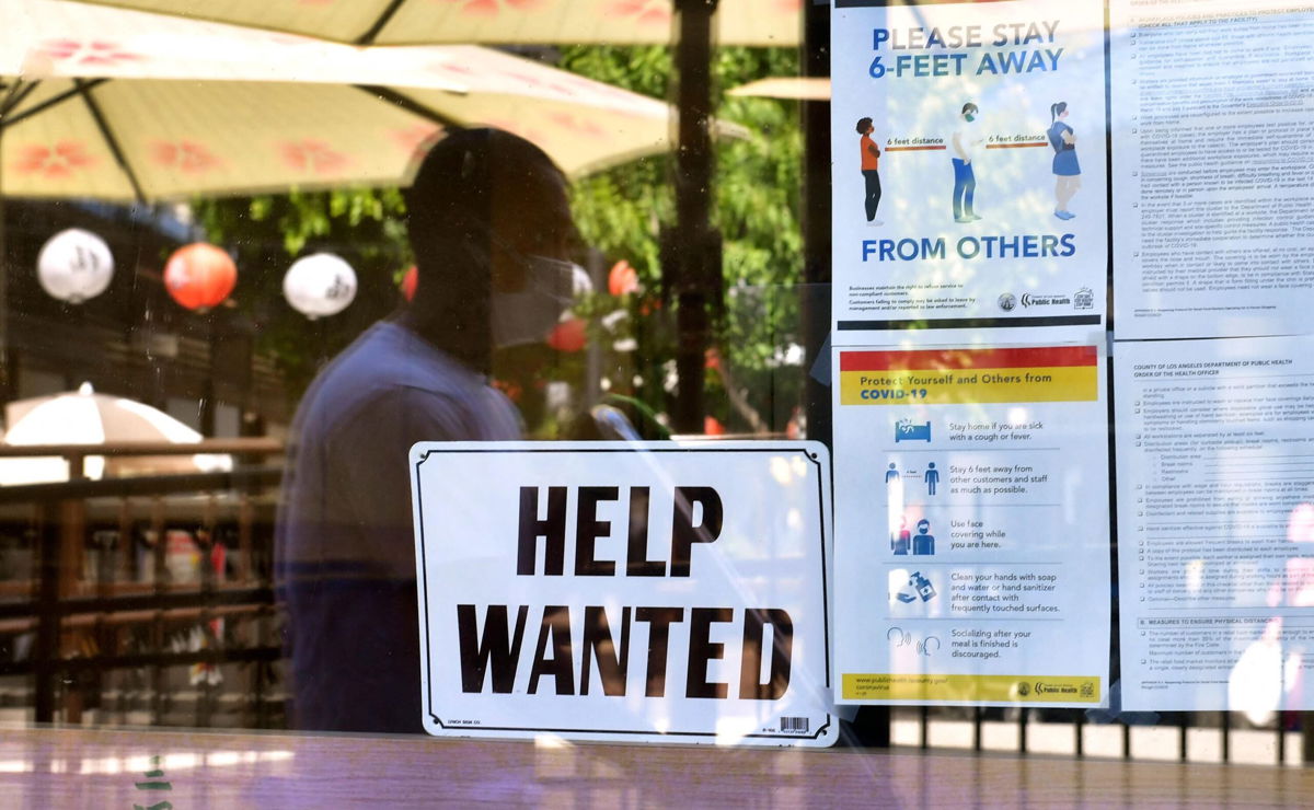 <i>FREDERIC J. BROWN/AFP/Getty Images</i><br/>A 'Help Wanted' sign is posted beside Coronavirus safety guidelines in front of a restaurant in Los Angeles