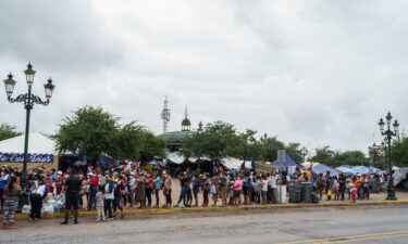 A Federal appeals court Thursday ordered the Biden administration to reinstate former President Donald Trump's 'remain in Mexico' policy.  Migrants here line up for food in a camp in Reynosa