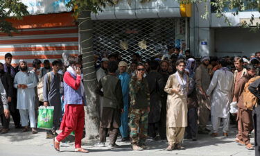 Afghans wait in long lines for hours to withdraw money