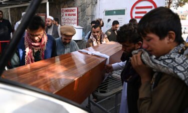 Relatives load in a car the coffin of a victim of the August 26th suicide attack