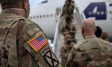 The Pentagon is mandating that US military service members get fully vaccinated against Covid-19 immediately. U.S. Army soldiers here return home from Afghanistan on December 10