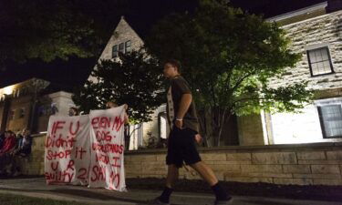 Protesters are seen holding banners outside the Phi Gamma Delta house on Aug. 26. Chancellor Ronnie Green on Sept. 1 told leaders of UNL's student government that he was committed to helping to prevent sexual assault on campus.