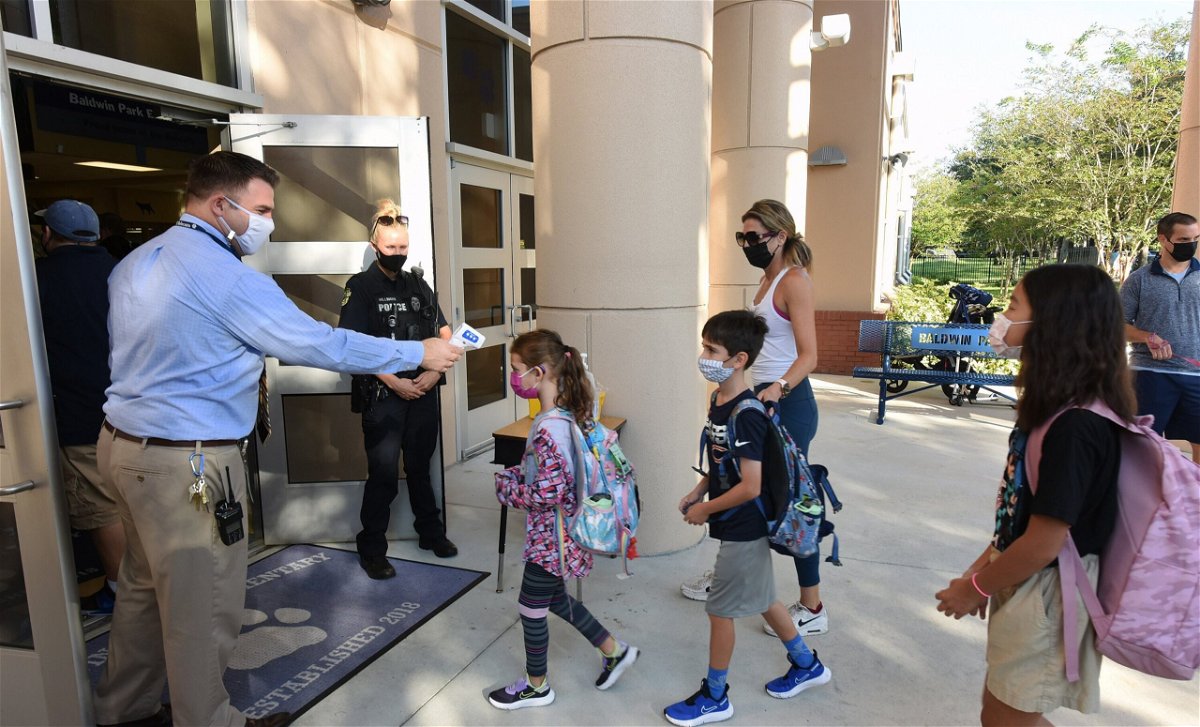 <i>Paul Hennessy/SOPA Images/LightRocket/Getty Images</i><br/>A Florida judge on Wednesday allowed schools in the state to mandate face masks while the case is appealed. Students here arrive on the first day of classes for the 2021-22 school year at Baldwin Park Elementary School.