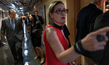 Sens. Kyrsten Sinema and Joe Manchin arrive for a bipartisan meeting on infrastructure in June.