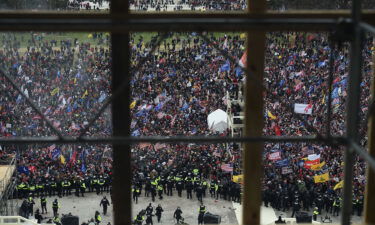 A pro-Trump supporter police officer told those under his command not to wear riot gear on January 6. This image shows rioters gathering outside the US Capitol's Rotunda on January 6