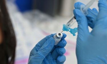 A healthcare worker fills a syringe with Pfizer Covid-19 vaccine at a community vaccination event in a predominately Latino neighborhood in Los Angeles