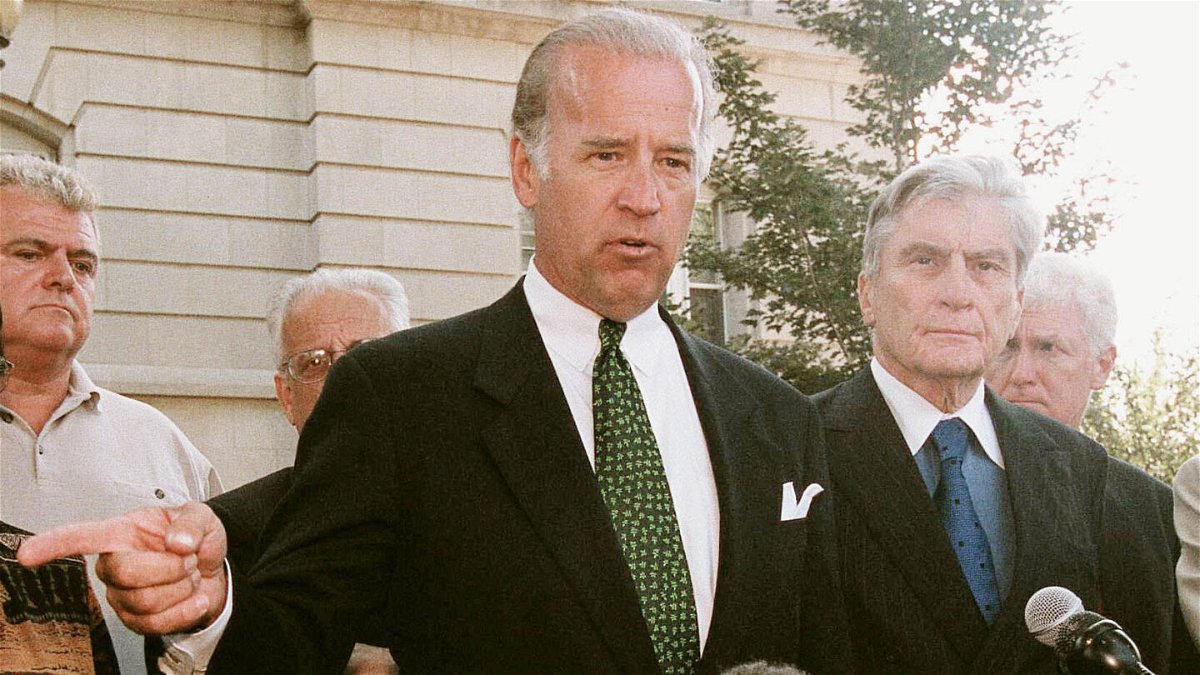 <i>Scott J. Ferrell/Congressional Quarterly/Getty Images</i><br/>Then-Senator Joe Biden speaks with the media alongside other members of Congress outside the U.S. Capitol Police Headquarters in the early afternoon of September 11