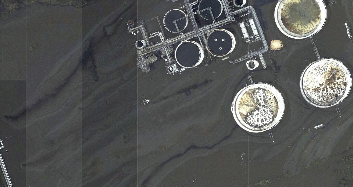 <i>NOAA/AP</i><br/>This image provided by NOAA taken on August 31 and reviewed by The Associated Press shows oil slicks at the flooded Phillips 66 Alliance Refinery in Belle Chasse