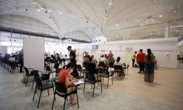 People wait in a vaccination center on August 7 in Bari