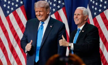 Former President Donald Trump and former Vice President Mike Pence give a thumbs up after speaking on the first day of the Republican National Convention at the Charlotte Convention Center on August 24