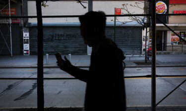 About 37.2 million people fell below the poverty line in 2020. People here walk through a shuttered business district in Brooklyn on May 12