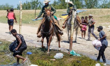 United States Border Patrol agents on horseback try to stop Haitian migrants from entering an encampment on the banks of the Rio Grande near the Acuna Del Rio International Bridge in Del Rio