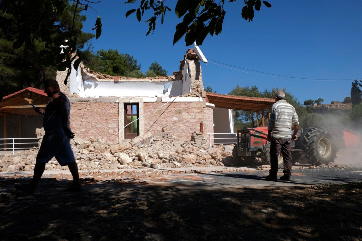 <i>Harry Nakos/AP</i><br/>Residents pass next to a damaged Greek Orthodox chapel after a strong earthquake in Arkalochori village on the southern island of Crete