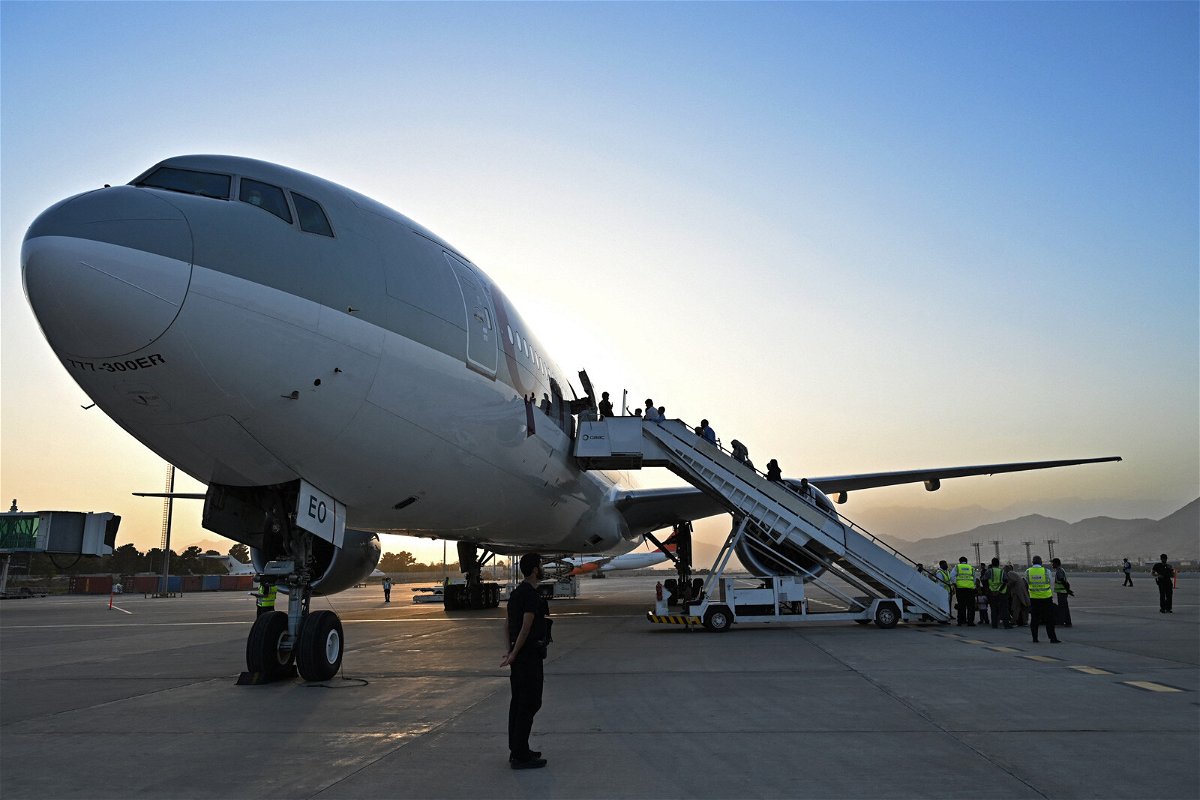 <i>Wakil Kohsar/AFP/Getty Images</i><br/>Passengers board a Qatar Airways aircraft at the airport in Kabul on Wednesday September 1.