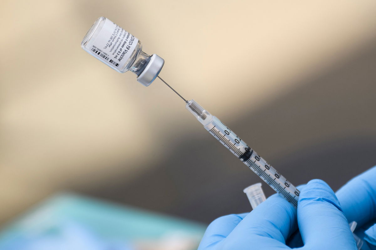 <i>Patrick T. Fallon/AFP/Getty Images</i><br/>A syringe is filled with a first dose of the Pfizer Covid-19 vaccine at a mobile vaccination clinic during a back-to-school event offering school supplies