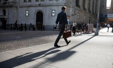 Pedestrians pass in front of the New York Stock Exchange in New York