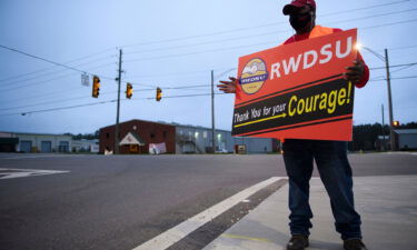 A union organizer stands outside an Amazon fulfillment center on March 27 in Bessemer
