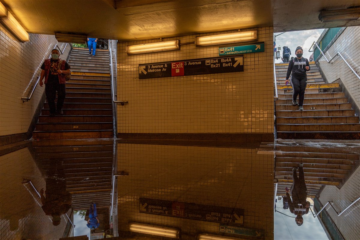 <i>David Dee Delgado/Getty Images</i><br/>People walk into a flooded subway station in New York City. Heavy rainfall from the remnants of Hurricane Ida disrupted service