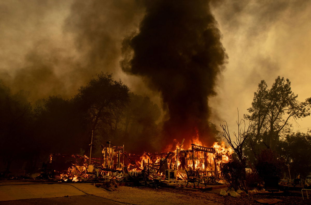 <i>Ethan Swope/AP</i><br/>Flames consume a house as the Fawn Fire burns north of Redding on September 23.
