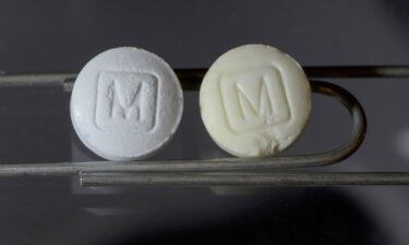 An image from the DEA shows an authentic 30mg oxycodone pill on the left