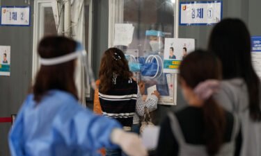 South Korea Covid-19 cases are at record highs as the country looks to relax virus restrictions. Pictured is a coronavirus makeshift testing site in Seoul