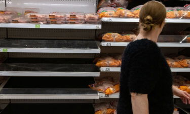 Shelves usually stocked with chicken stand empty at an Asda supermarket on September 19 in London.