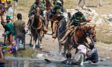 United States Border Patrol agents on horseback tries to stop Haitian migrants from entering an encampment on the banks of the Rio Grande near the Acuna Del Rio International Bridge in Del Rio