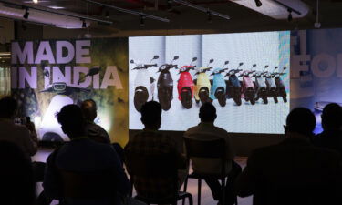 Attendees listen to presentations on a screen during the launch of the Ola Electric Scooter at the Ola Campus in Bengaluru