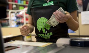 An employee works at a cash register at a Dollar Tree store in Chicago.