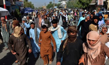 Local residents march against a reported announcement by the Taliban