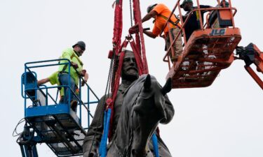 Crews work to remove the towering statue of Confederate General Robert E. Lee on Monument Avenue