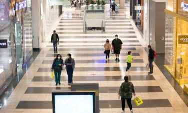 Customers wearing face masks visit a shopping mall on August 3 in San Francisco